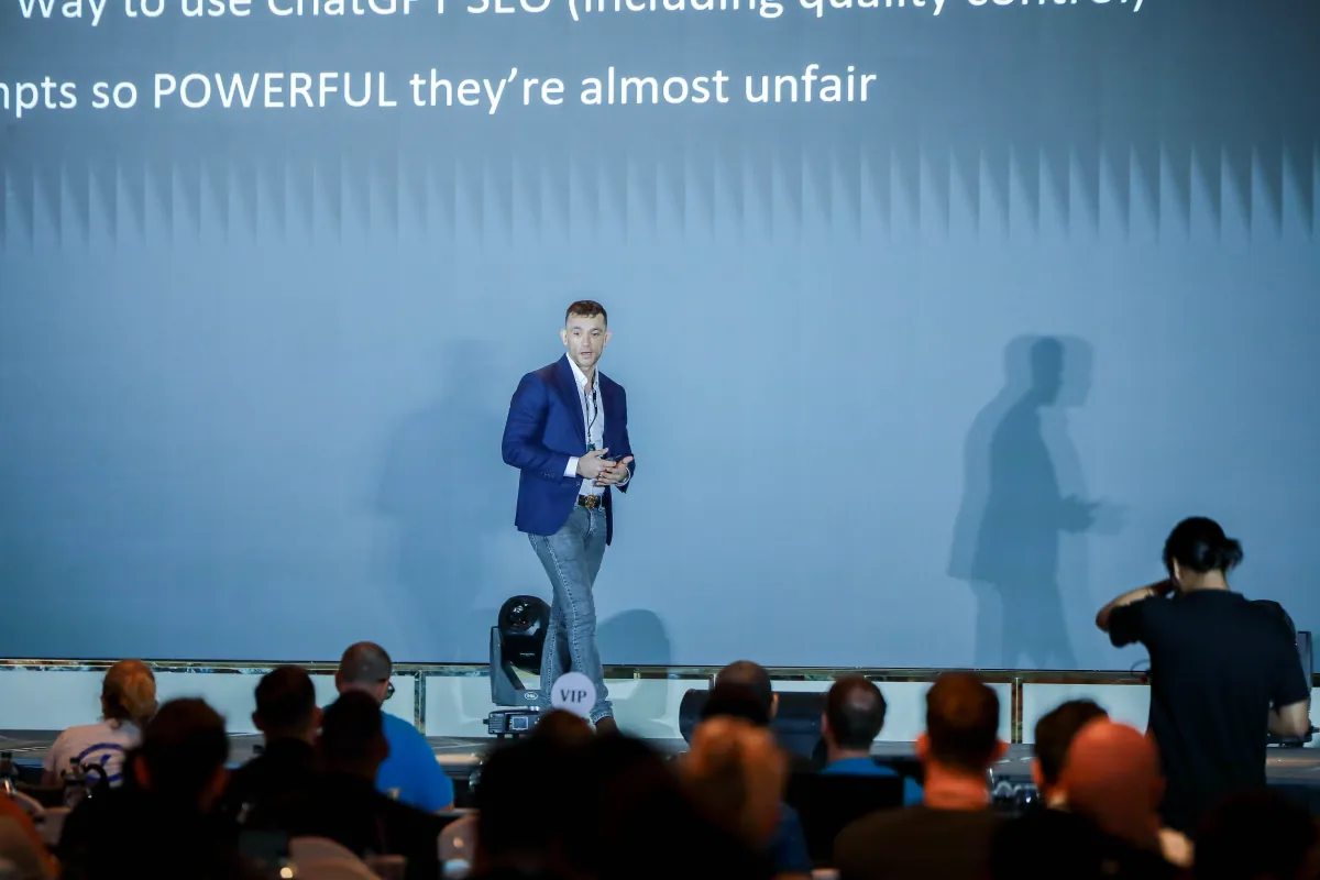 Julian speaking to a full room at an AI conference